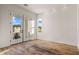 Hallway bathed in light from large windows and glass doors to the outside at 17396 W Crawfordsville Dr, Surprise, AZ 85388