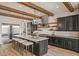 Modern kitchen with stainless steel appliances, a large island, and stylish pendant lighting at 17396 W Crawfordsville Dr, Surprise, AZ 85388