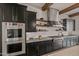 Well-appointed kitchen featuring high-end appliances and exposed shelving at 17396 W Crawfordsville Dr, Surprise, AZ 85388