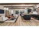 Spacious open-concept living area with wood beam ceilings, a gourmet kitchen, and hardwood floors at 17396 W Crawfordsville Dr, Surprise, AZ 85388
