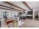 Spacious living room featuring exposed wood beams, an open floor plan, and modern decor at 17396 W Crawfordsville Dr, Surprise, AZ 85388