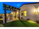 A covered outdoor stainless steel grill and well-manicured backyard offer an inviting space for outdoor cooking and relaxation at 17396 W Crawfordsville Dr, Surprise, AZ 85388