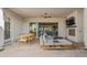 Spacious outdoor patio with dining area, comfortable seating, fireplace and seamless indoor-outdoor flow at 17396 W Crawfordsville Dr, Surprise, AZ 85388