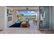 A patio with a nice fireplace, fan, and tv that is overlooking a well-kept backyard at 17396 W Crawfordsville Dr, Surprise, AZ 85388