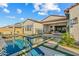 Inviting backyard oasis with a sparkling pool, lounge chairs, and lush landscaping at 17396 W Crawfordsville Dr, Surprise, AZ 85388