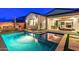 Luxurious backyard with a modern pool, seamless indoor-outdoor living, and elegant landscaping for serene relaxation and entertainment at 17396 W Crawfordsville Dr, Surprise, AZ 85388