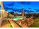 Outdoor oasis featuring a modern pool, lounge chairs, and built-in grill, perfect for relaxation and outdoor entertainment at 17396 W Crawfordsville Dr, Surprise, AZ 85388