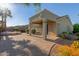 Backyard with covered patio, fire pit, spa, and well-manicured landscaping at 17517 W Dahlia Dr, Surprise, AZ 85388