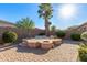 Beautiful backyard with spa, firepit, and lush landscaping, perfect for relaxing and entertaining at 17517 W Dahlia Dr, Surprise, AZ 85388