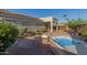 Scenic backyard featuring a patio, fire pit, and hot tub for outdoor enjoyment at 17517 W Dahlia Dr, Surprise, AZ 85388
