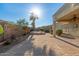 Expansive brick-paved backyard with desert landscaping, covered patio and private pool/hot tub area at 17517 W Dahlia Dr, Surprise, AZ 85388