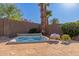 Inviting backyard featuring a relaxing hot tub with nearby towels, perfect for unwinding at 17517 W Dahlia Dr, Surprise, AZ 85388