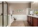 Bright bathroom featuring a soaking tub with glass enclosure, and vanity with granite counters at 17517 W Dahlia Dr, Surprise, AZ 85388