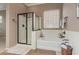 This bright bathroom includes a shower, soaking tub, and tiled floors at 17517 W Dahlia Dr, Surprise, AZ 85388