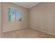 Neutral toned bedroom with a window allowing for natural light at 17517 W Dahlia Dr, Surprise, AZ 85388