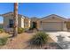 Beautiful front of the home featuring desert landscaping, a covered porch, and a two-car garage at 17517 W Dahlia Dr, Surprise, AZ 85388