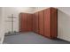 Garage with built-in wood cabinets and epoxy floor, offering ample storage at 17517 W Dahlia Dr, Surprise, AZ 85388