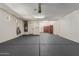 Well-lit garage with epoxy floor and ample space for storage and parking vehicles at 17517 W Dahlia Dr, Surprise, AZ 85388