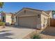 Attractive home with a two-car garage and desert landscaping at 17517 W Dahlia Dr, Surprise, AZ 85388