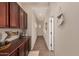 Hallway with tiled floors, built-in cabinetry, and decorative elements creating a warm atmosphere at 17517 W Dahlia Dr, Surprise, AZ 85388
