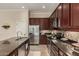 Well-equipped kitchen with stainless appliances, granite counters and an island with seating at 17517 W Dahlia Dr, Surprise, AZ 85388