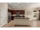Open kitchen features a center island, stainless steel appliances, and rich wood cabinetry at 17517 W Dahlia Dr, Surprise, AZ 85388