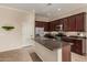 Spacious kitchen includes a center island with granite countertops and stainless steel appliances at 17517 W Dahlia Dr, Surprise, AZ 85388