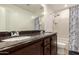 Bathroom with double sink vanity, large mirror, and shower-tub combo with marble print shower curtain at 20816 E Duncan St, Queen Creek, AZ 85142