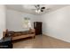 Cozy bedroom features a ceiling fan, neutral colors, and tiled floors with a window providing natural light at 20816 E Duncan St, Queen Creek, AZ 85142