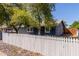 Charming single-story home featuring a well-maintained yard, mature trees and a classic white picket fence at 20816 E Duncan St, Queen Creek, AZ 85142