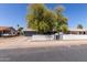 Charming single-story home featuring a well-maintained yard, mature trees and a classic white picket fence at 20816 E Duncan St, Queen Creek, AZ 85142
