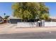 Charming single-story home featuring a well-maintained yard, mature trees and a classic white picket fence at 20816 E Duncan St, Queen Creek, AZ 85142