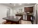 This immaculate kitchen features granite countertops, stainless steel appliances, and a convenient kitchen island at 20816 E Duncan St, Queen Creek, AZ 85142