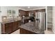Featuring granite countertops, the gourmet kitchen boasts stainless steel appliances and ample storage at 20816 E Duncan St, Queen Creek, AZ 85142