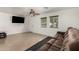 Bright living room with tile flooring, ceiling fan, a tv, and a comfortable reclining couch at 20816 E Duncan St, Queen Creek, AZ 85142
