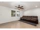 Bright living room with tile flooring, ceiling fan, and large windows offering natural light at 20816 E Duncan St, Queen Creek, AZ 85142