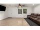 Bright living room with tile flooring, ceiling fan, and large windows offering natural light at 20816 E Duncan St, Queen Creek, AZ 85142