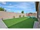 Spacious backyard featuring a well-maintained lawn, ample space for recreation, and a block wall for added privacy at 23871 N 167Th Ln, Surprise, AZ 85387