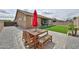 Charming backyard with patio table and chairs, complemented by artificial grass and neutral gravel at 23871 N 167Th Ln, Surprise, AZ 85387