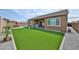 Spacious backyard features artificial turf, a patio seating area, and is enclosed by a privacy wall, perfect for outdoor living at 23871 N 167Th Ln, Surprise, AZ 85387