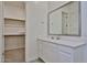 Bathroom with modern white cabinetry, stone countertops, and access to a walk-in closet at 23871 N 167Th Ln, Surprise, AZ 85387