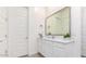 Clean bathroom featuring a vanity with white cabinets and a framed mirror at 23871 N 167Th Ln, Surprise, AZ 85387