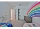 Spacious bedroom with rainbow wall art, closet and neutral carpet flooring at 23871 N 167Th Ln, Surprise, AZ 85387