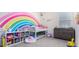 Charming ' bedroom with a rainbow wall mural, bunk beds, and playful decor at 23871 N 167Th Ln, Surprise, AZ 85387