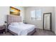 Comfortable bedroom with a plush bed, soft lighting, and a large window offering natural light at 23871 N 167Th Ln, Surprise, AZ 85387