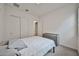Neutral bedroom boasts carpet flooring, a gray dresser, a bed with white patterned comforter and ample closet space at 23871 N 167Th Ln, Surprise, AZ 85387