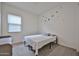 Simple bedroom with window light, star accents, and neutral tones for a minimalist look at 23871 N 167Th Ln, Surprise, AZ 85387