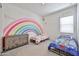 Playful bedroom with rainbow wall art, and whimsical decorations for a shared ' space at 23871 N 167Th Ln, Surprise, AZ 85387