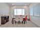 This dining room features a sleek glass-top table, seating for six, and ample natural light at 23871 N 167Th Ln, Surprise, AZ 85387