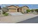 Charming single-story home featuring a two-car garage and low-maintenance landscaping at 23871 N 167Th Ln, Surprise, AZ 85387